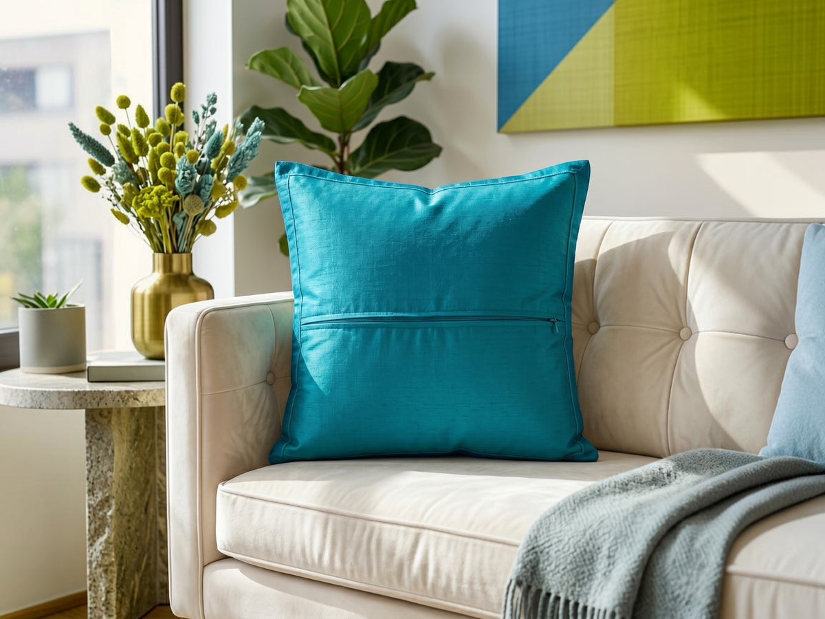 Jagdish Store decorative cushion cover with blue floral polysilk appliqué on a textured lime green polysilk-blend background.
