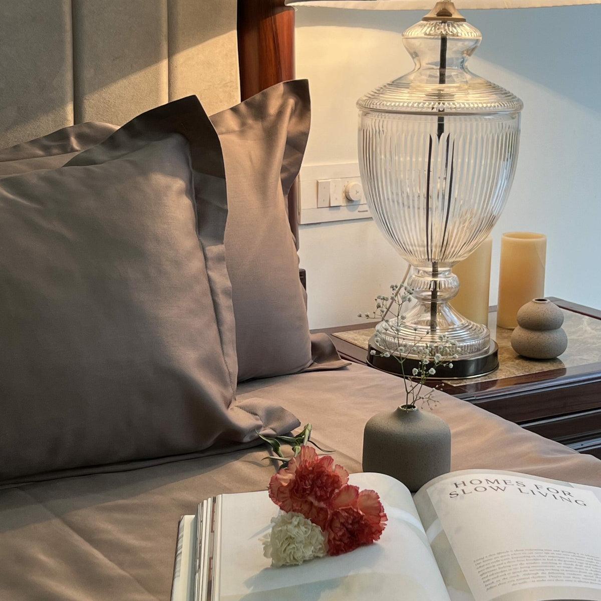 Taupe sateen pillows beside a crystal lamp, Taupe Luxe Collection