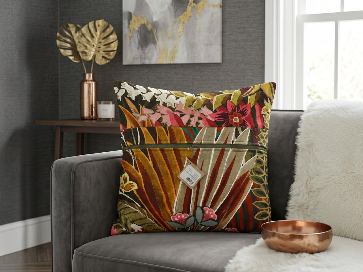 Tropical botanical printed cotton cushion cover featuring colorful leaves and floral motifs on a sofa