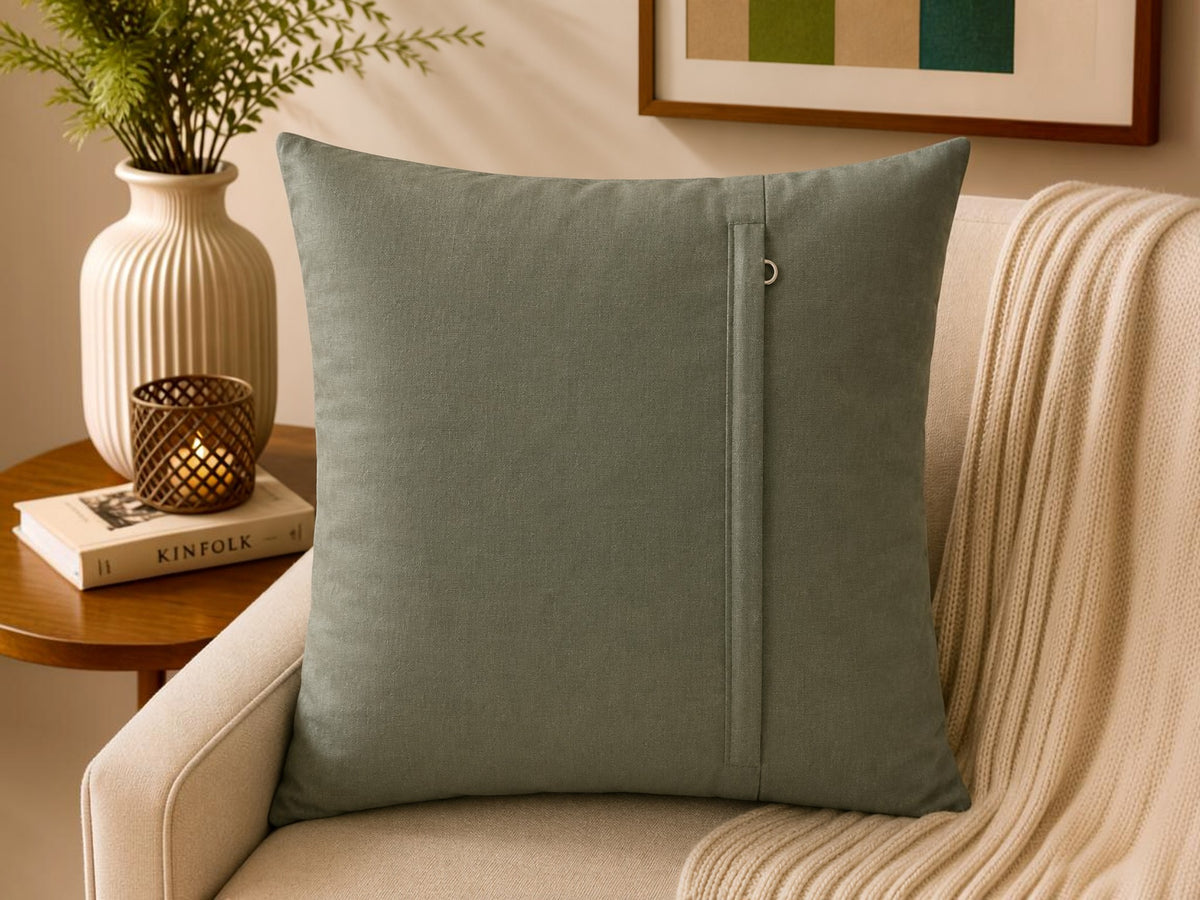 Sage green polysilk cushion cover featuring embroidered motifs with decorative bead work accents