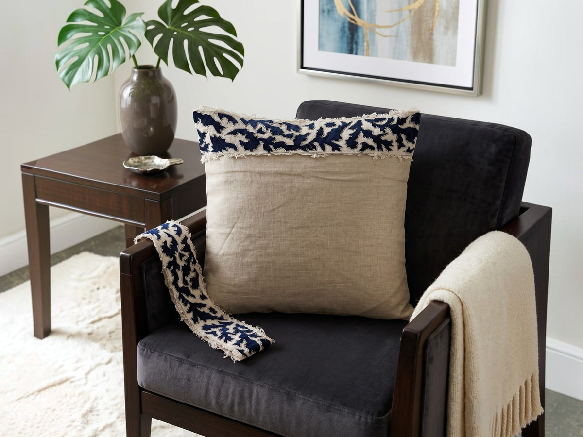 Beige cushion cover with detachable black patterned accent strip