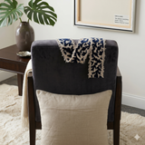 Beige cushion cover with detachable black patterned accent strip
