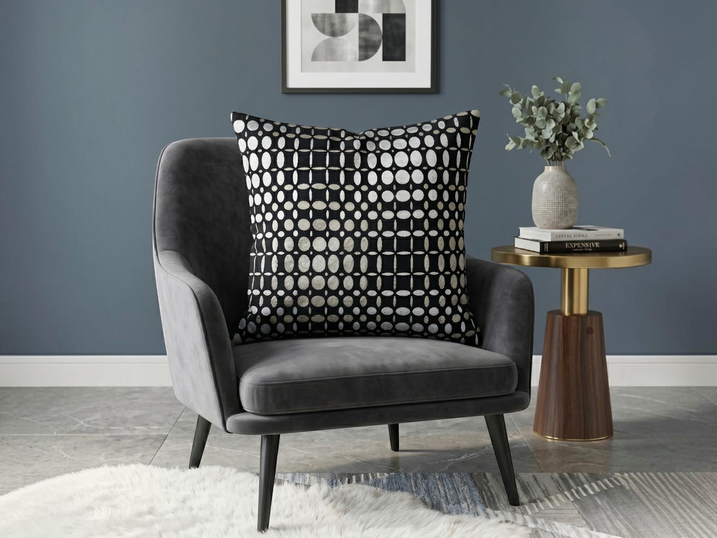 Black velvet cushion cover with geometric woven circular pattern in contrasting ivory tones
