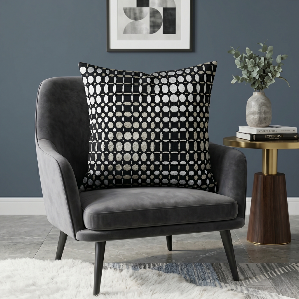 Black velvet cushion cover with geometric woven circular pattern in contrasting ivory tones