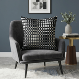 Black velvet cushion cover with geometric woven circular pattern in contrasting ivory tones