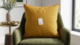 Green polysilk cushion cover with textured diagonal panel design and decorative button accents