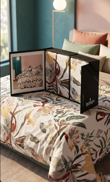 Bed dressed in a cream botanical print bedsheet with the open Voyage gift box