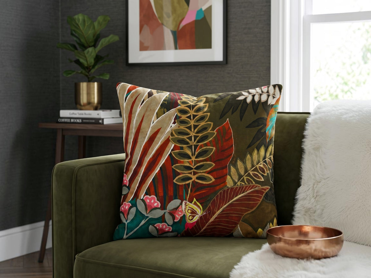 Tropical botanical printed cotton cushion cover featuring colorful leaves and floral motifs on a sofa