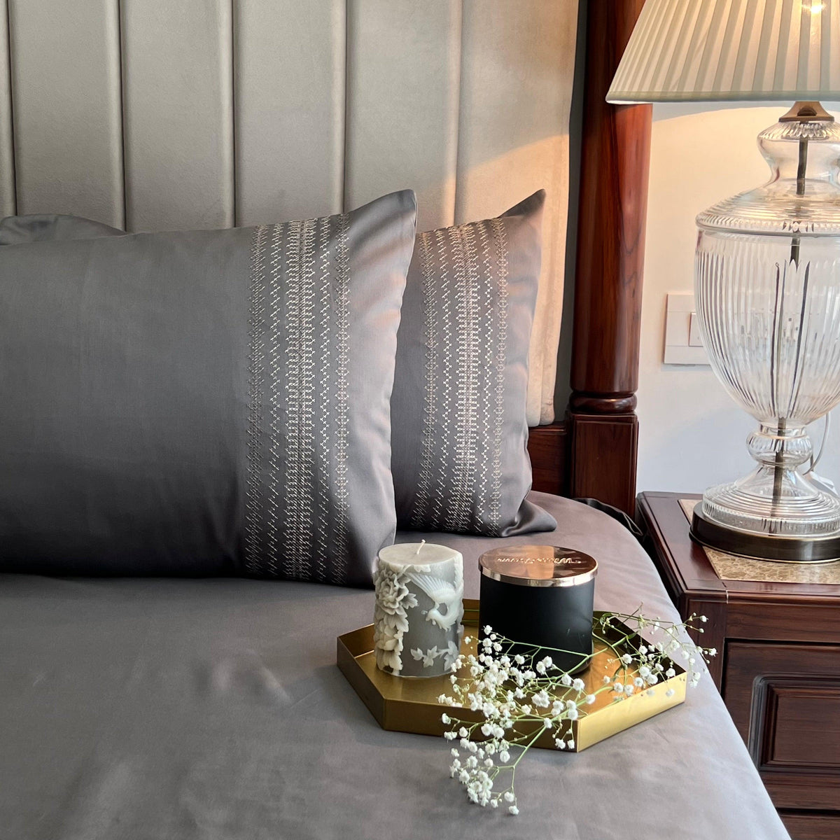 Elephant grey bedding with a cream and gold embroidered pillow band