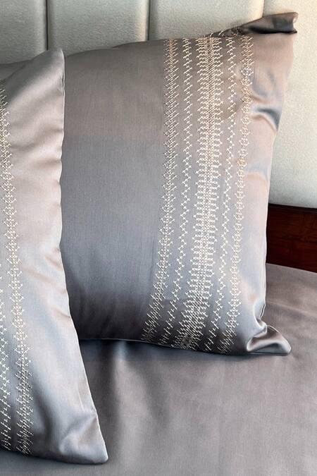 Elephant grey bedding with a cream and gold embroidered pillow band