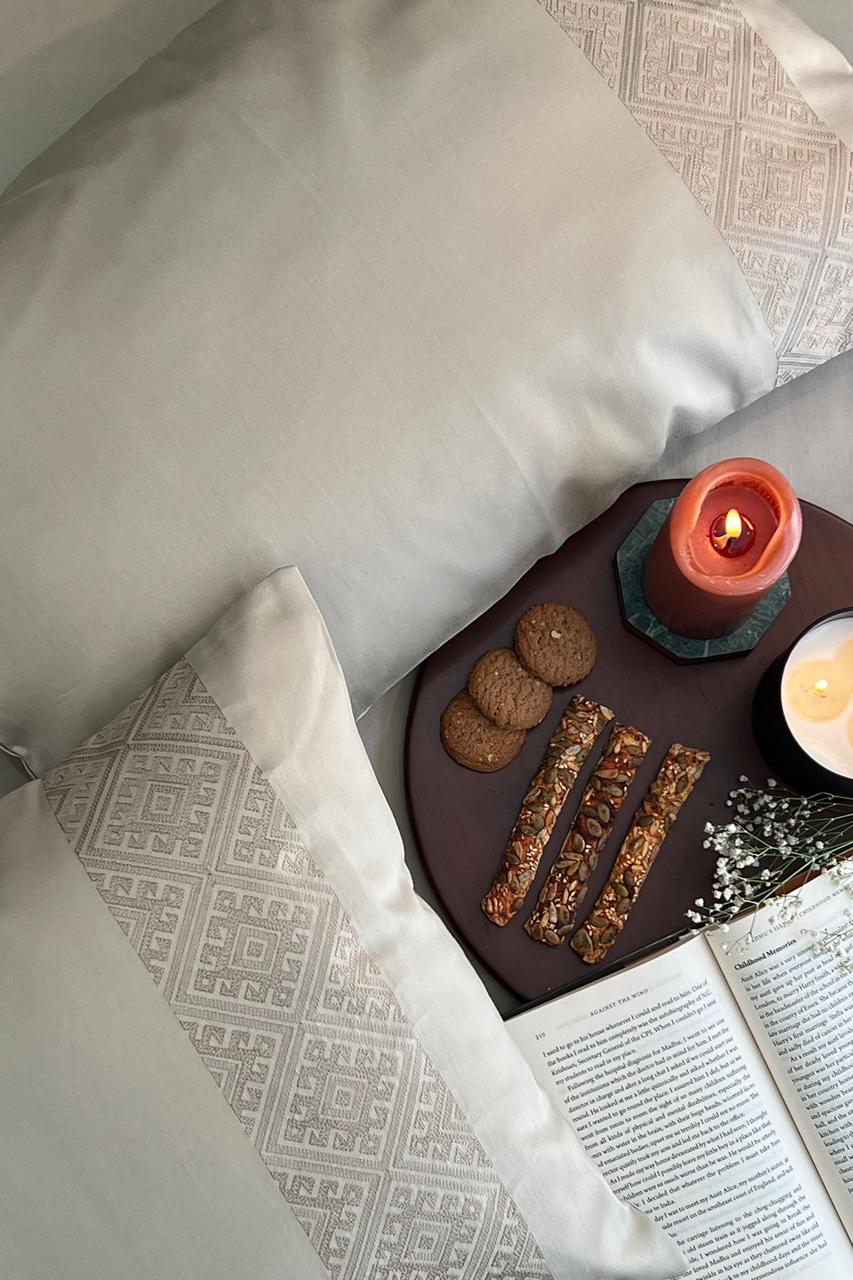 Ivory embroidered-panel pillows with a coffee tray, Beige Arcane Collection