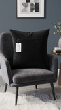 Black velvet cushion cover with geometric woven circular pattern in contrasting ivory tones