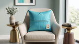 Blue plain polysilk cushion cover on a beige accent chair with a smooth solid color finish