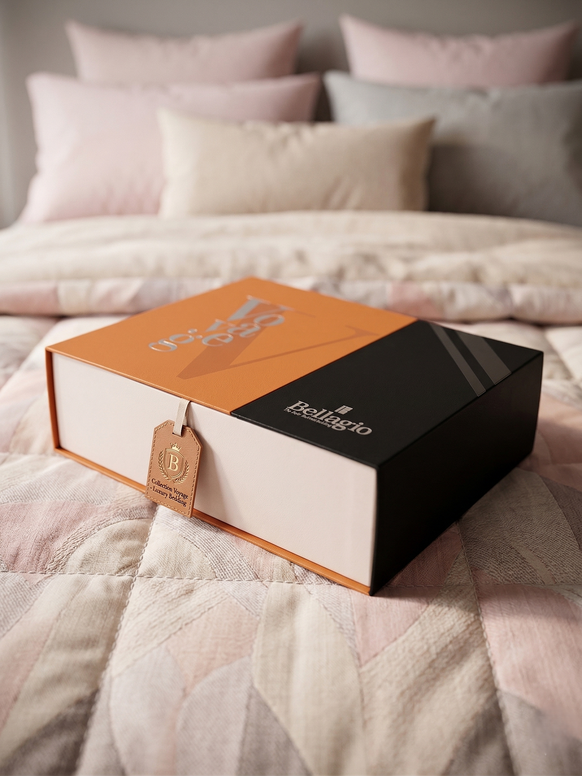 Closed Voyage gift box with its gift tag on blush quilted bedding