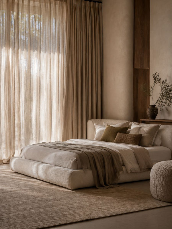 Bedroom with soft sheer curtains letting in daylight