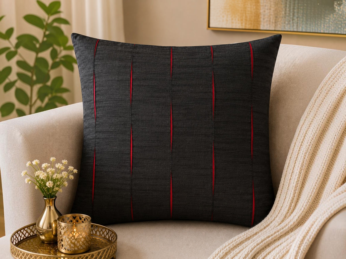 Jagdish Store black decorative throw cushion cover with pleated vertical channels revealing vibrant red accents.