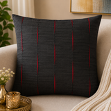 Jagdish Store black decorative throw cushion cover with pleated vertical channels revealing vibrant red accents.