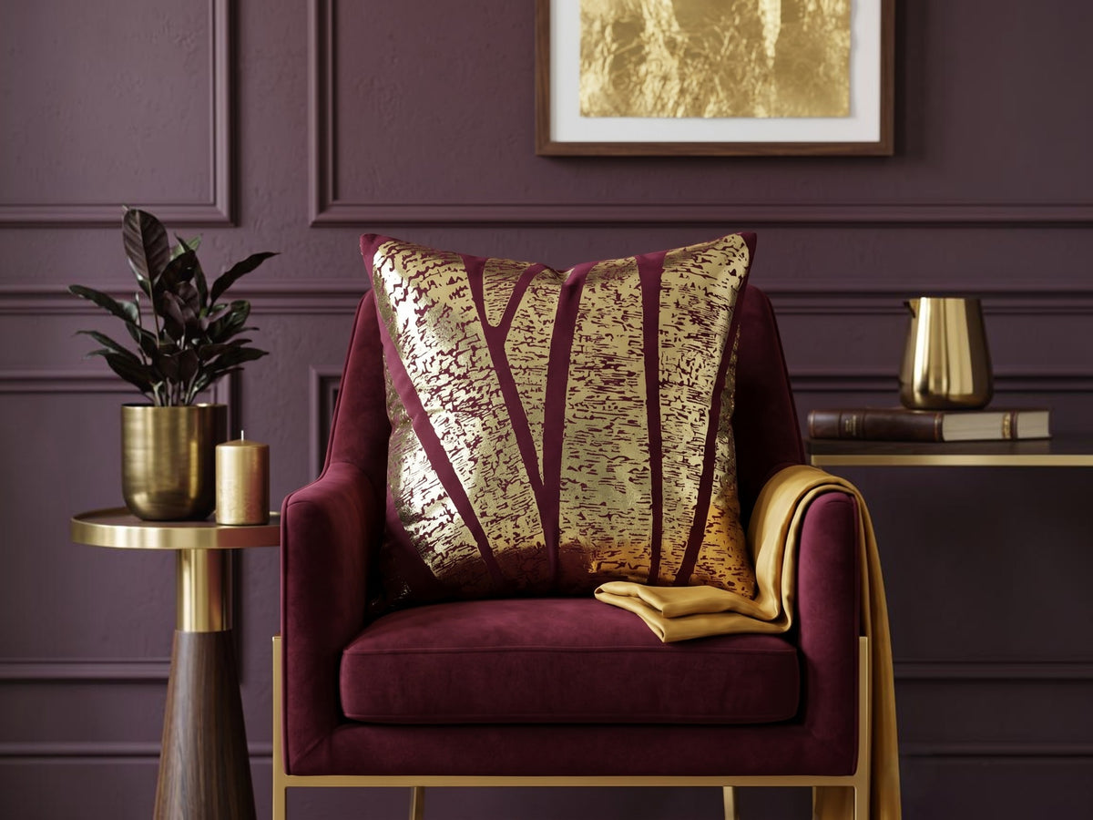 Jagdish Store burgundy cushion cover with abstract gold foil pattern for a luxurious modern home decor accent.
