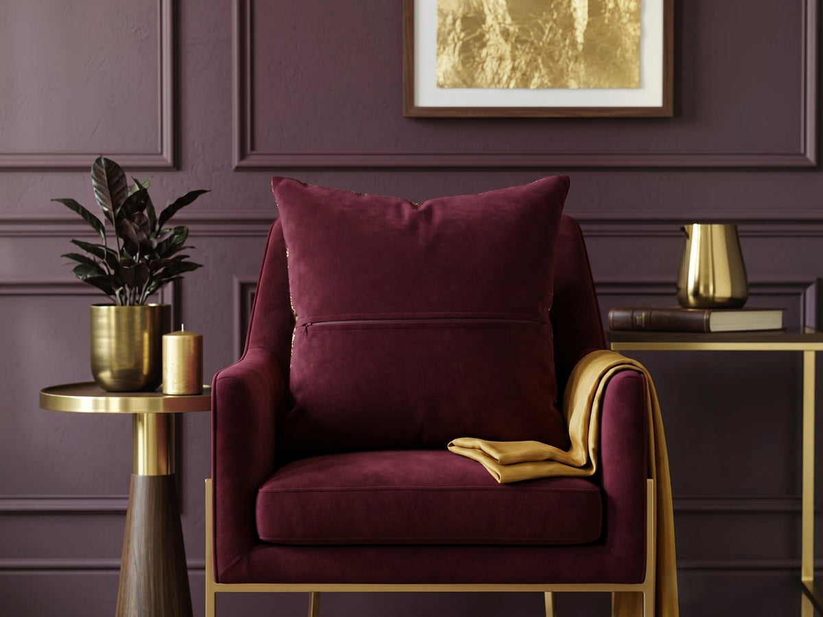 Jagdish Store burgundy cushion cover with abstract gold foil pattern for a luxurious modern home decor accent.