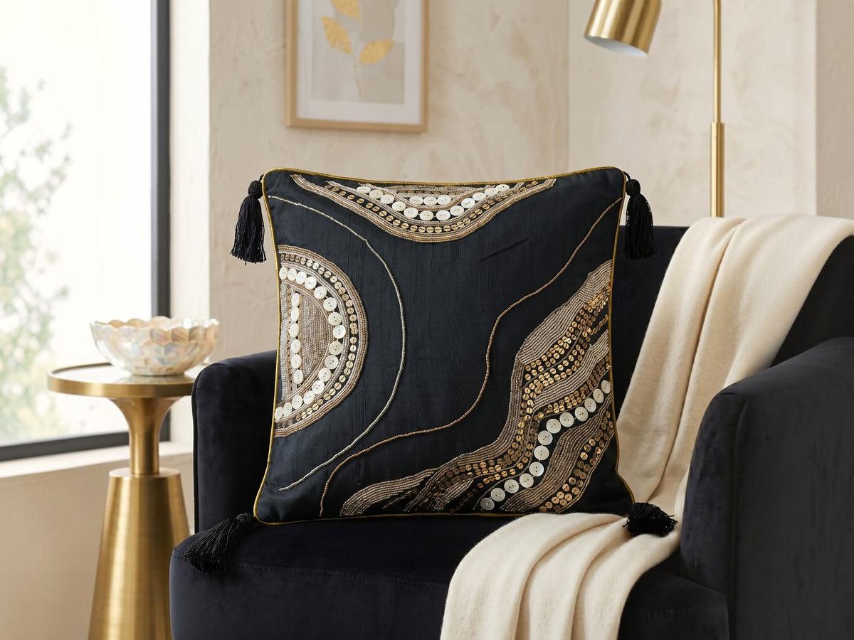 Jagdish Store midnight blue cushion cover with gold sequins, glass beads, white buttons, and black corner tassels.