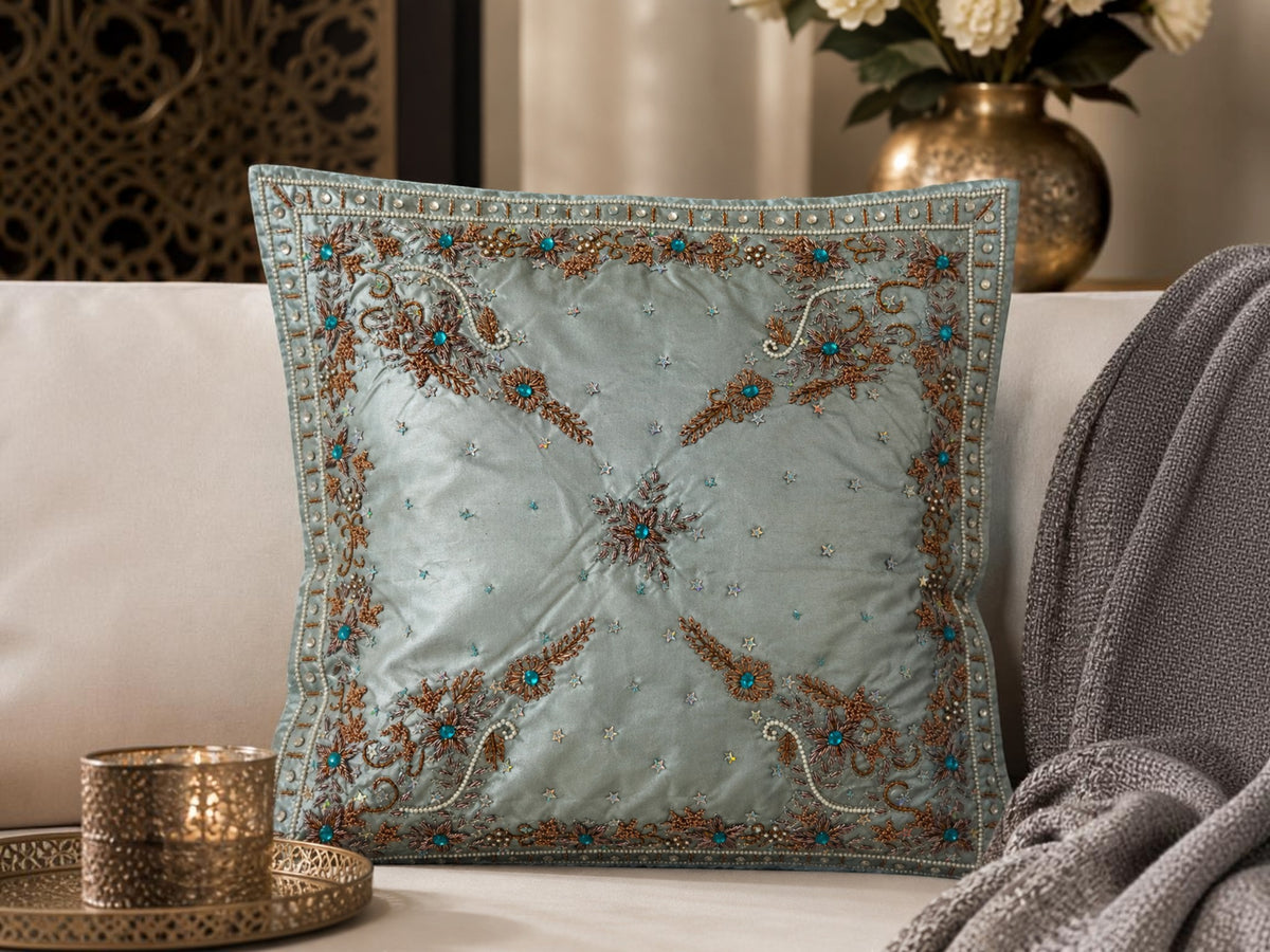 Jagdish Store light blue satin throw pillow cover with copper embroidery, sequins, and turquoise faux gemstones.