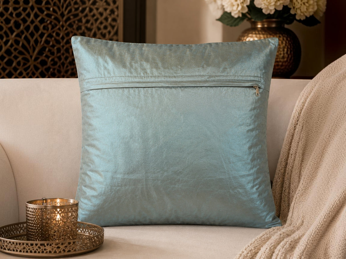 Jagdish Store light blue satin throw pillow cover with copper embroidery, sequins, and turquoise faux gemstones.