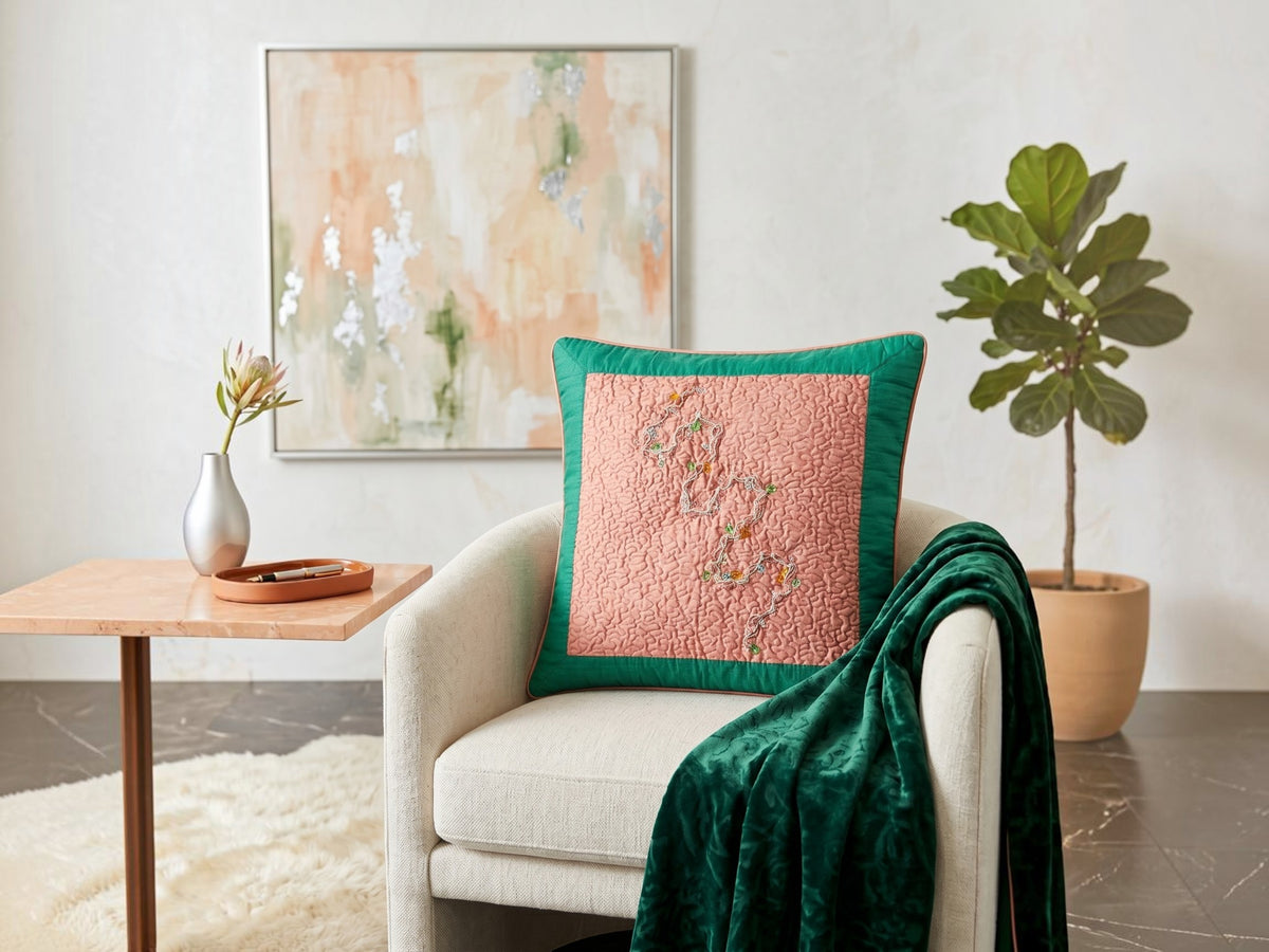 Jagdish Store pink quilted cushion cover with embroidered silver thread, colorful beads, and emerald green border.