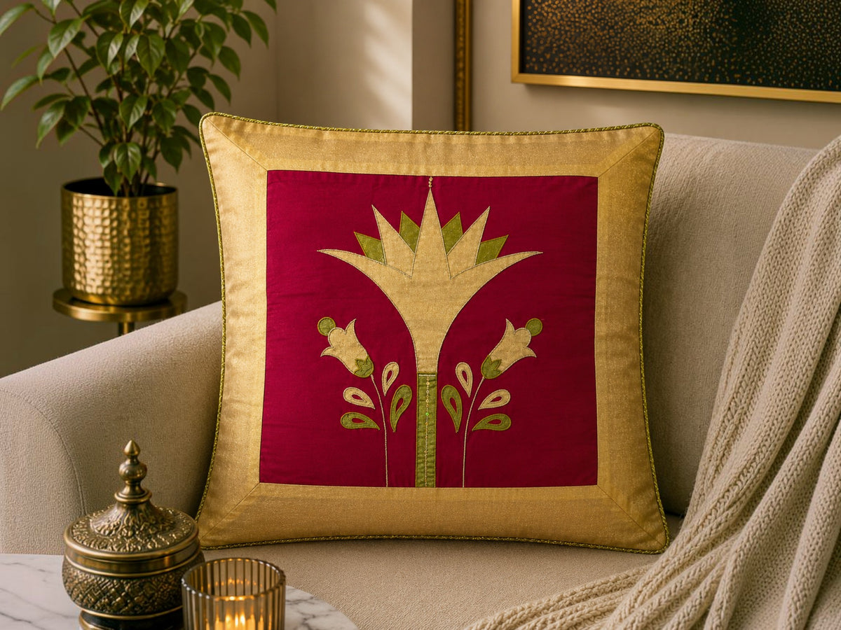 Jagdish Store decorative cushion cover with crimson red fabric, gold lotus embroidery, and gold trim. Features green accents.