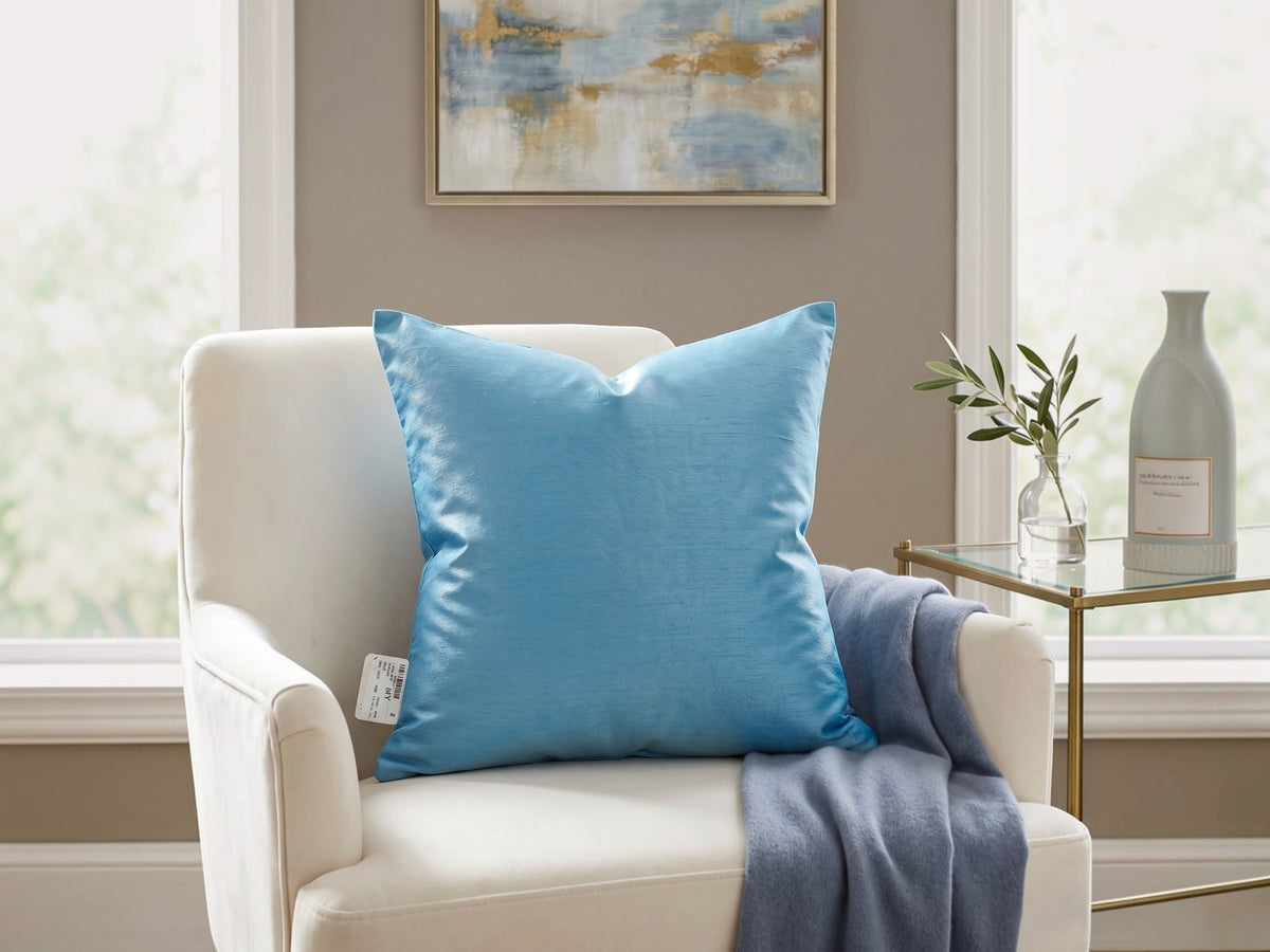 Jagdish Store embroidered decorative cushion cover in shimmering turquoise with teal, white, and gold floral embroidery and teal striped panels.