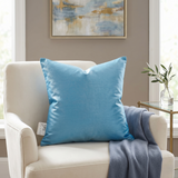Jagdish Store embroidered decorative cushion cover in shimmering turquoise with teal, white, and gold floral embroidery and teal striped panels.
