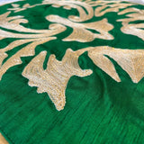 Jagdish Store emerald green throw pillow cover with intricate shimmering gold floral embroidery and gold piping.