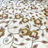 Jagdish Store cream cushion cover with gold and burgundy floral embroidery and delicate beadwork accents.