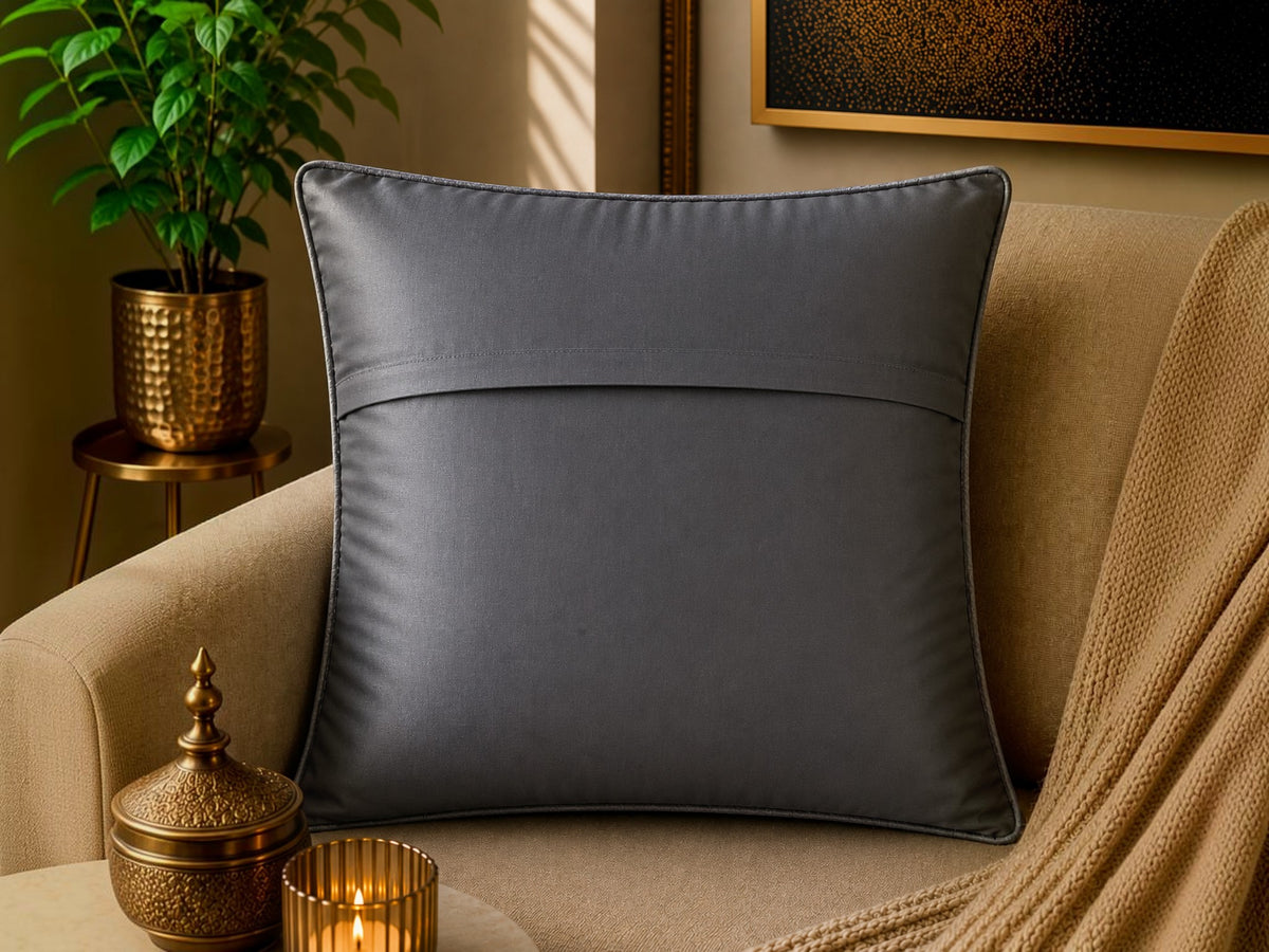 Jagdish Store grey textured cushion cover with overlapping circular discs and colorful rings in neon pink, teal, orange, and lime green.
