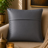 Jagdish Store grey textured cushion cover with overlapping circular discs and colorful rings in neon pink, teal, orange, and lime green.