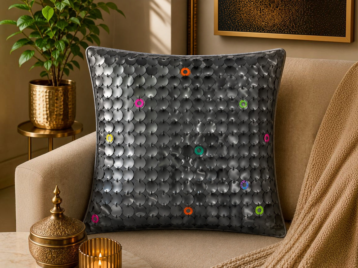 Jagdish Store grey textured cushion cover with overlapping circular discs and colorful rings in neon pink, teal, orange, and lime green.