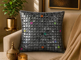 Jagdish Store grey textured cushion cover with overlapping circular discs and colorful rings in neon pink, teal, orange, and lime green.