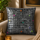 Jagdish Store grey textured cushion cover with overlapping circular discs and colorful rings in neon pink, teal, orange, and lime green.