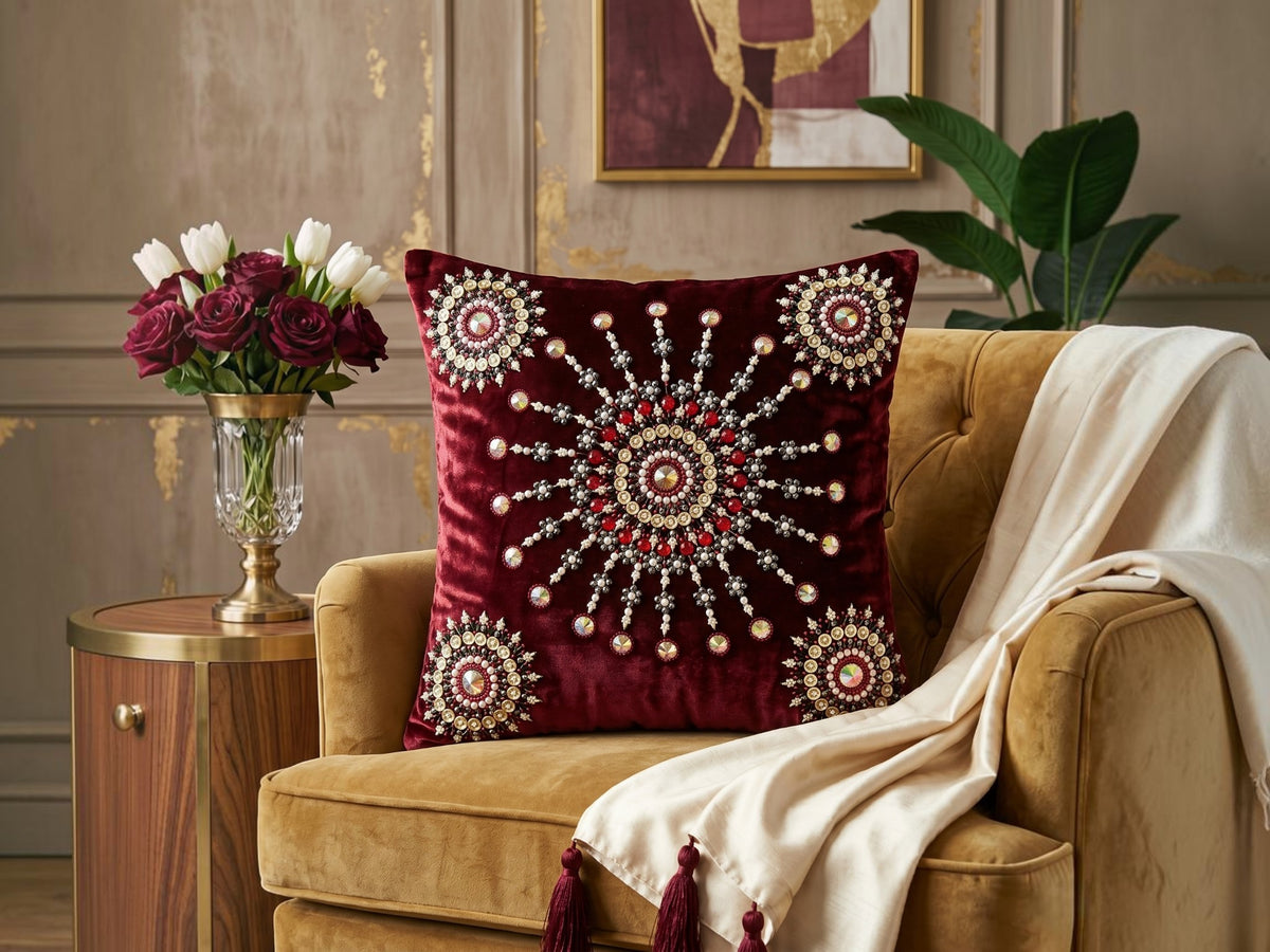 Jagdish Store maroon velvet cushion cover with intricate beaded mandala embroidery and decorative crystal accents.