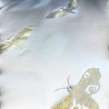 Jagdish Store off-white throw pillow cover with metallic gold moth print and delicate embellishments.
