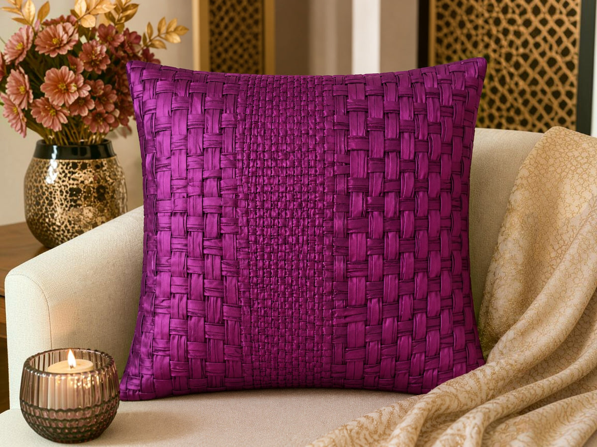 Purple woven pillow on a beige couch with decorative elements.