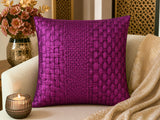 Purple woven pillow on a beige couch with decorative elements.