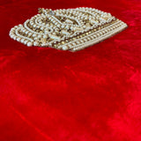 Jagdish Store red velvet cushion cover featuring a hand-embellished crown motif with faux pearls and gold accents.