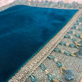 Jagdish Store teal velvet throw pillow cover with woven border and dangling crystal bead fringe trim.