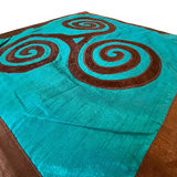 Jagdish Store turquoise throw pillow cover with a brown triskele spiral pattern and matching border.