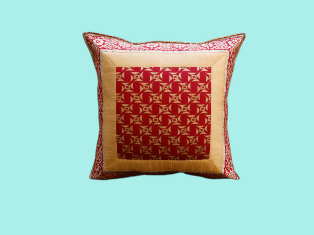 Maroon and gold geometric medallion art silk cushion cover with a gold silk border