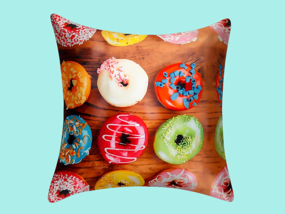 Cushion cover printed with iced doughnuts in bright colours on a wooden background