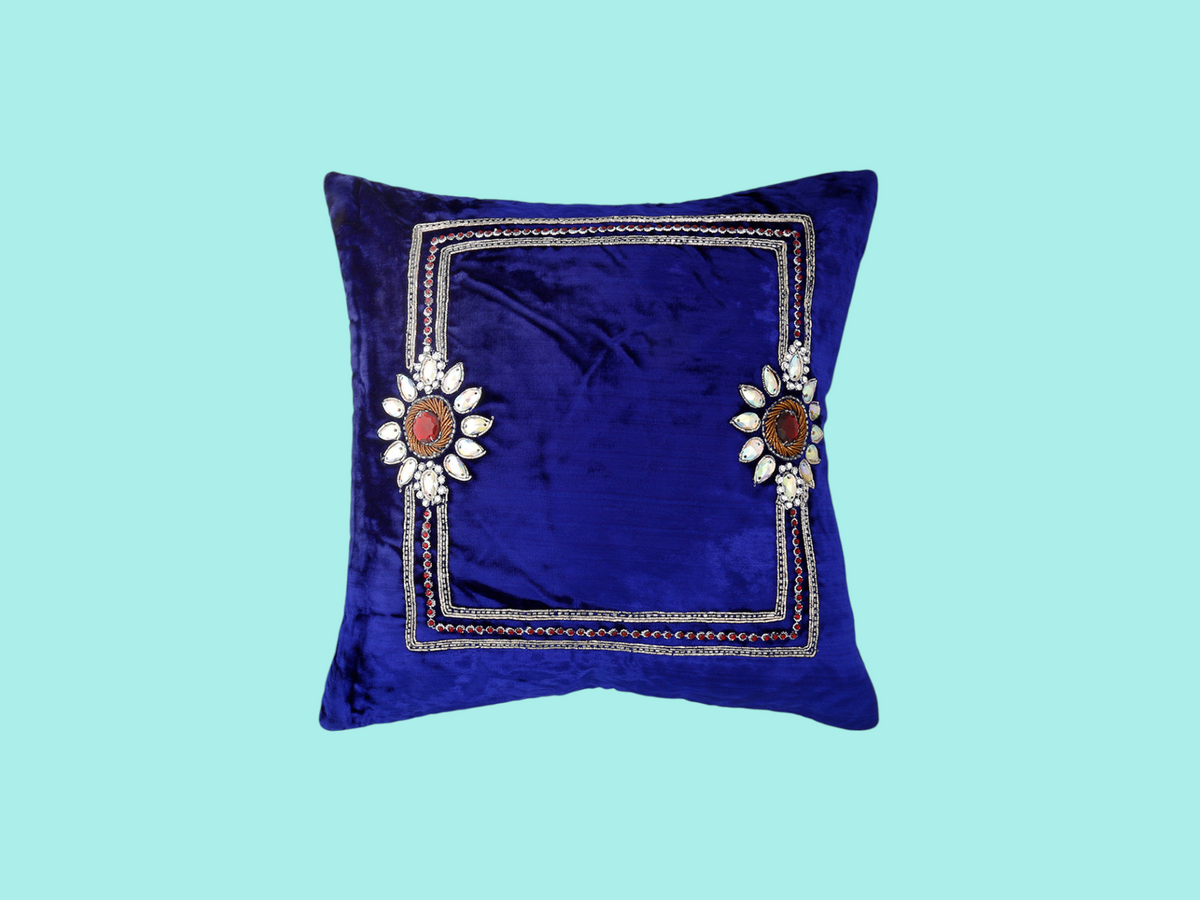 Royal blue velvet cushion cover with a silver zari embroidered border and floral medallions