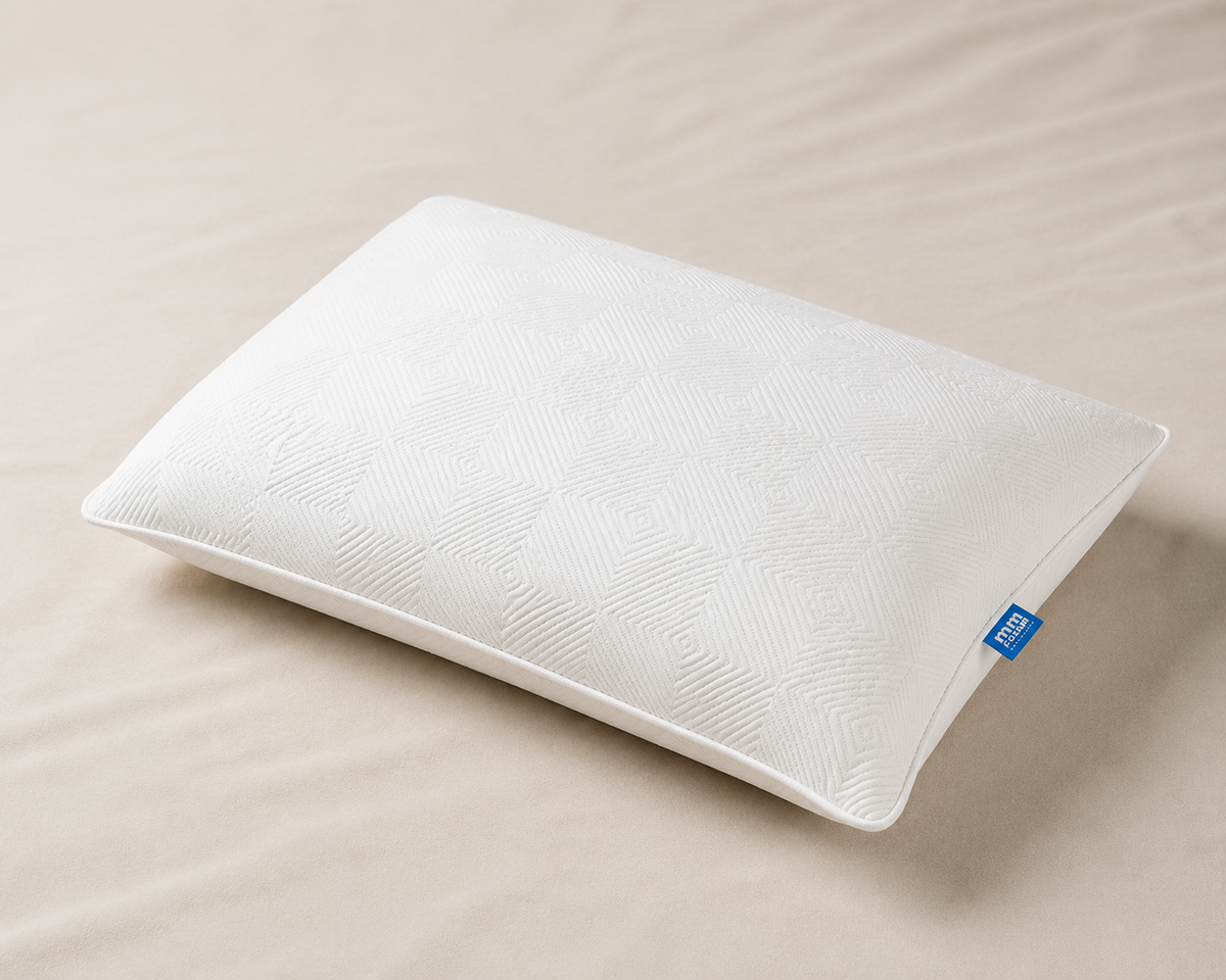 White latex pillow on a bed, mmFoam Snuggle Pillow
