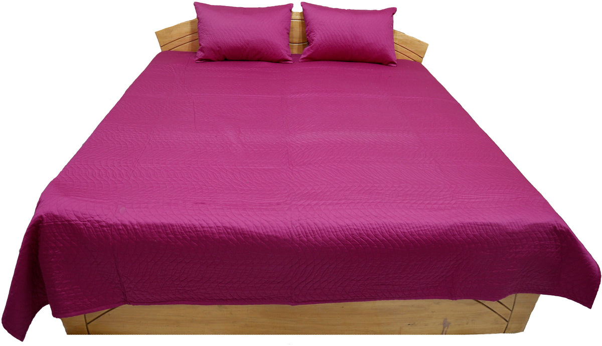 Magenta reverse side of the quilted bedcover with matching magenta pillow covers