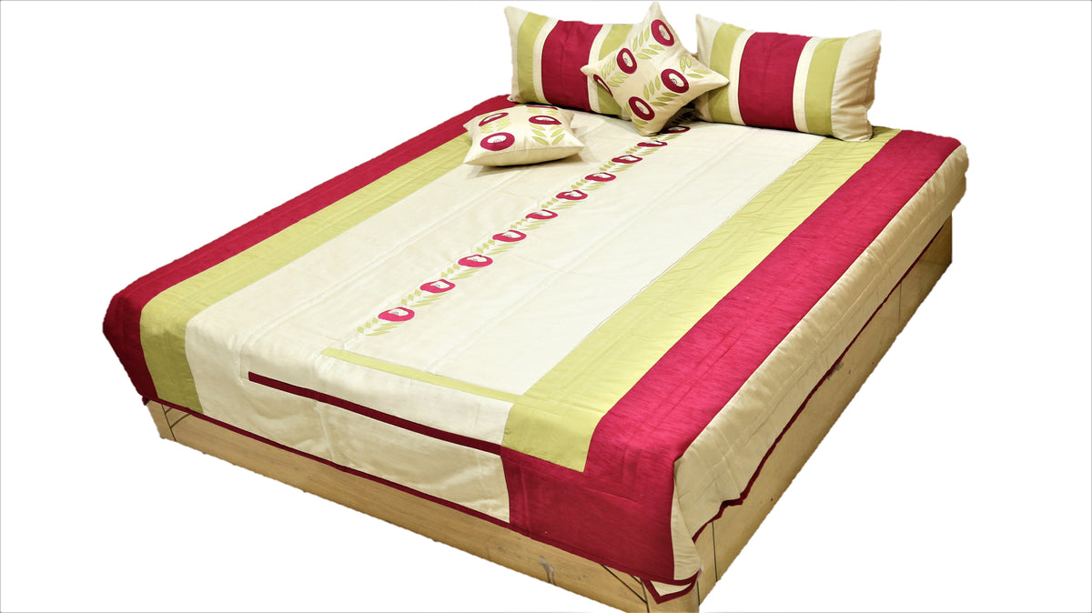 Cream and crimson striped quilted bedcover set made up on a double bed with bolsters